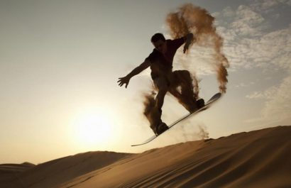 sandboarding on red dunes